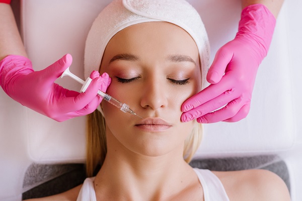 a woman having dermal fillers injected