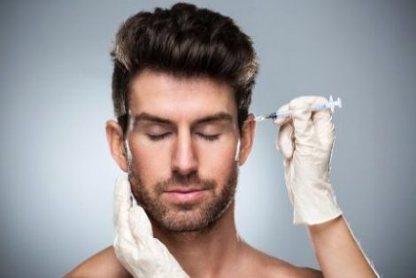 man receiving a botox injection in his forehead