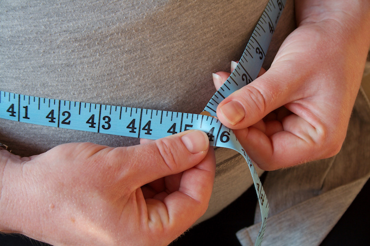 Tape measure around woman's waist