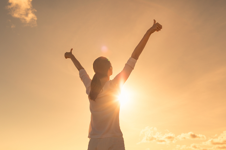 Young woman relaxing in summer sunset sky outdoor.