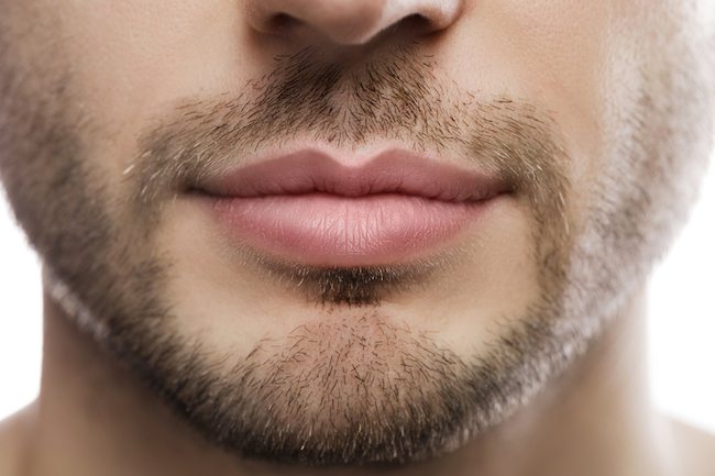 Close-up of perfect male plump lips after filler injection