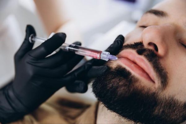man getting lip filler injection